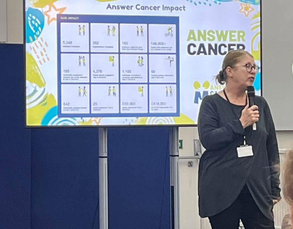 Speaker presenting the impact of the Answer Cancer programme at the Answer Cancer Champion Award Ceremony