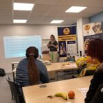 Facilitator presenting digital skills for job applications at a Community Upskilling employability session in Salford