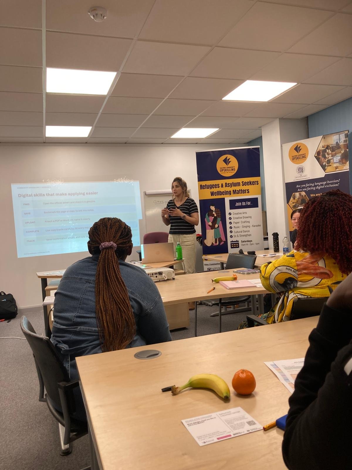 Facilitator presenting digital skills for job applications at a Community Upskilling employability session in Salford