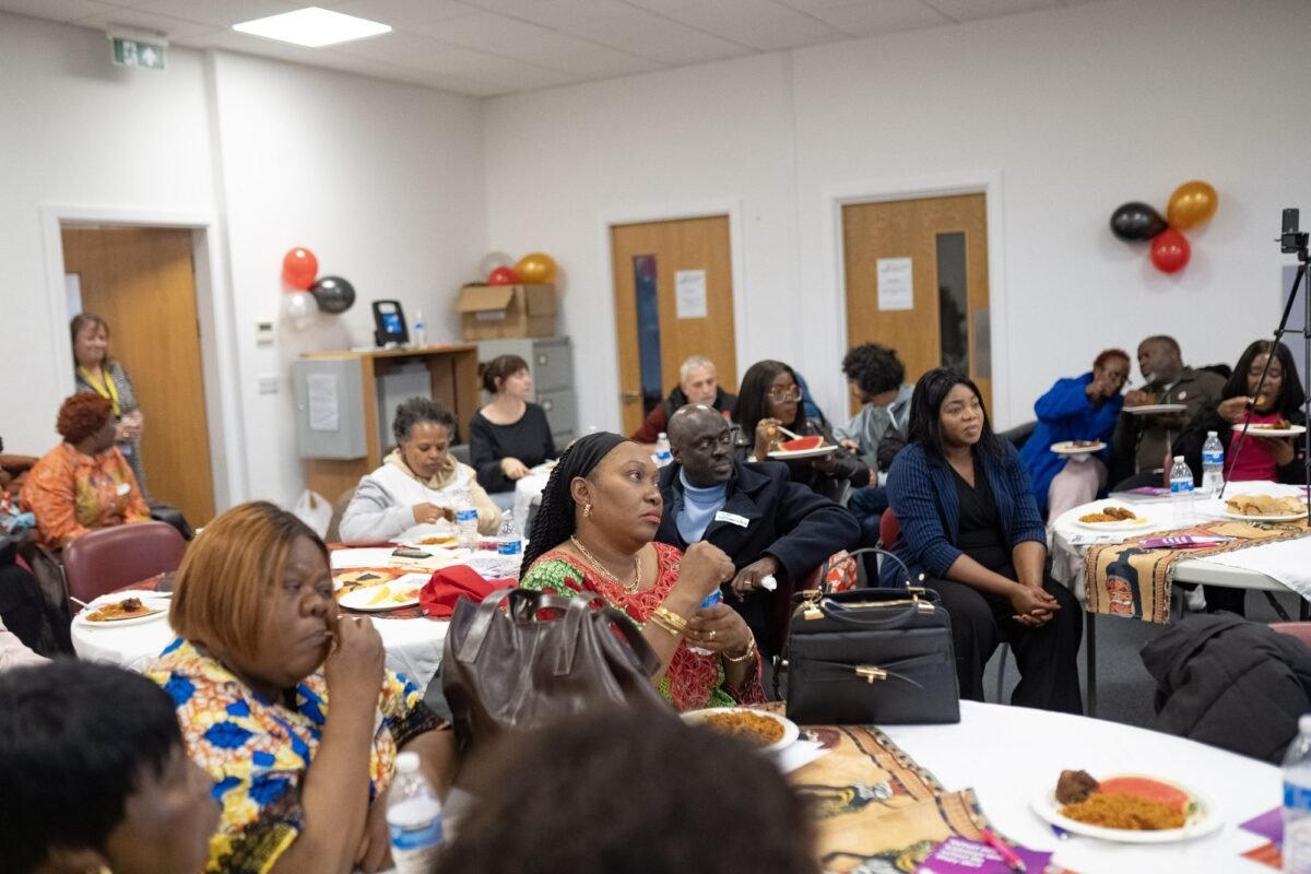 Guests seated at tables during the Honouring Our Communities Black History Month celebration in Salford