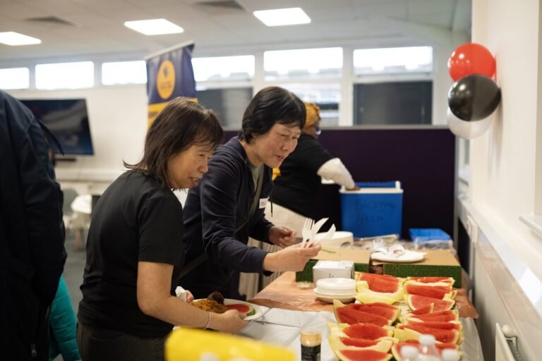 Volunteers serving food at the celebration