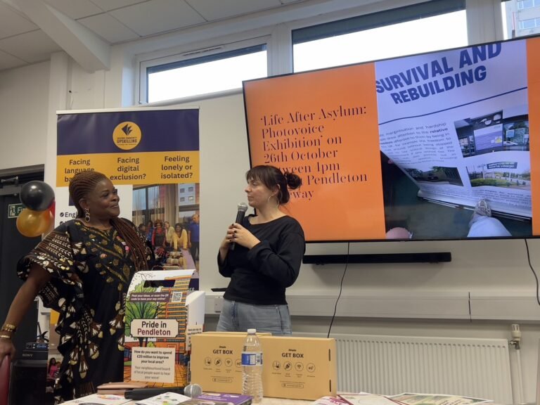 Two guest speakers at the front of the room during the celebration