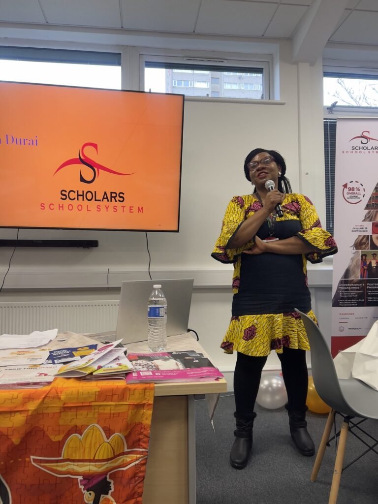 A speaker in a yellow outfit at the front of the room